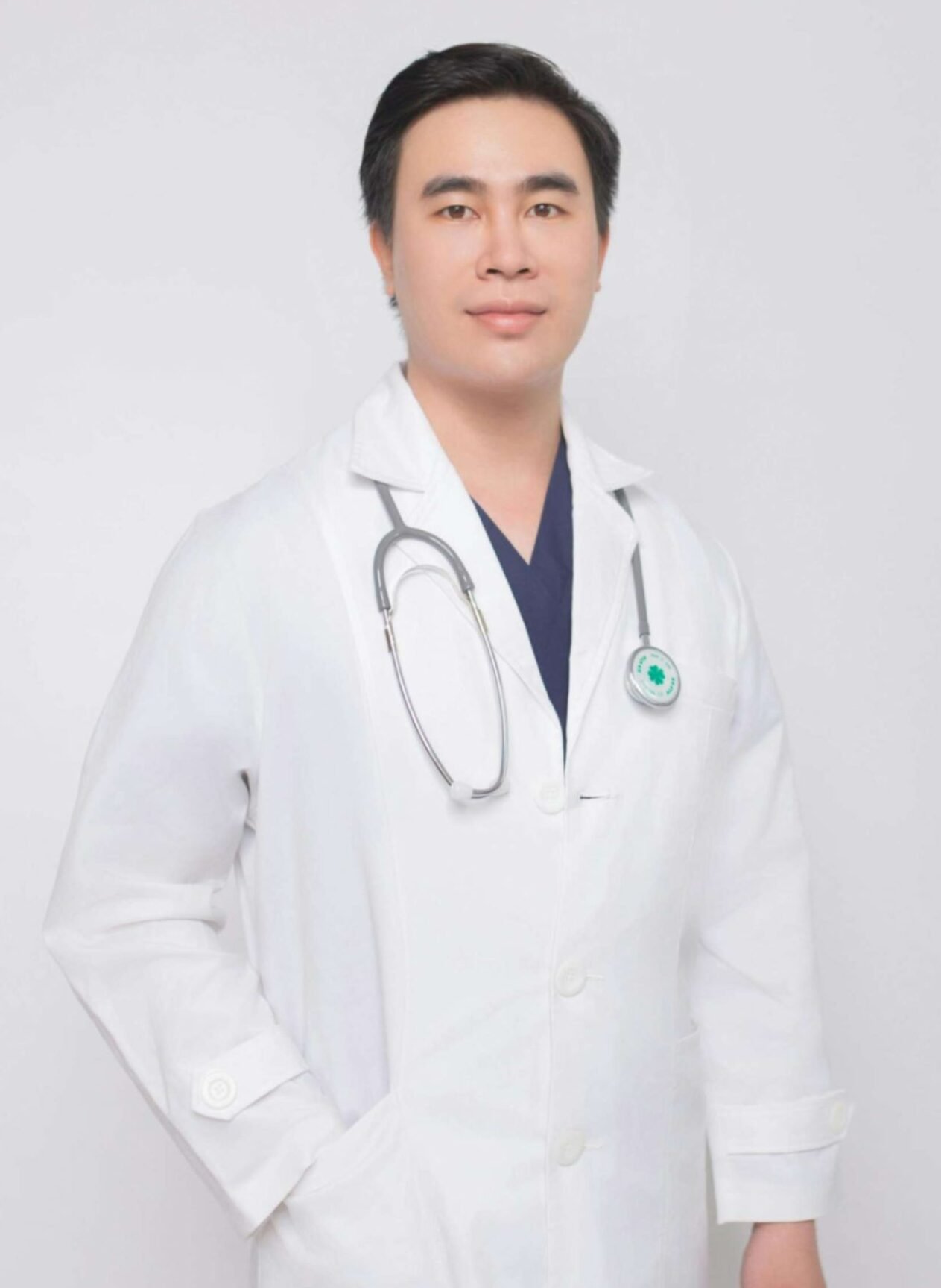 Orthodontist Dr. Oliver Denton in a white coat with a stethoscope, representing the dental team at Peak Performance Health.